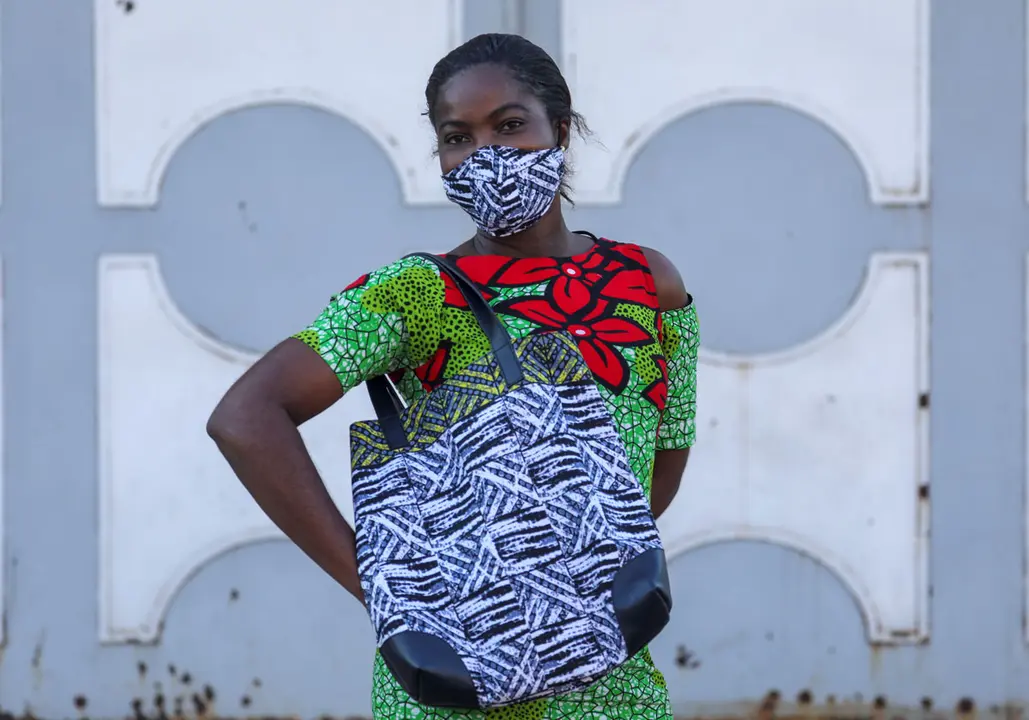 A model of Arthur Bella N&#39;guessan, an Ivorian designer, poses as she wears a protective face mask with colors matching her clothes, amid the coronavirus disease (COVID-19) outbreak, in Angre area of Abidjan, Ivory Coast May 13, 2020. REUTERS/Luc Gnago