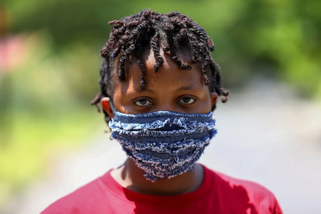A woman poses for a picture with a fabric face mask on, following the spread of the coronavirus disease (COVID-19) in Lagos, Nigeria May 14, 2020. REUTERS/Temilade Adelaja