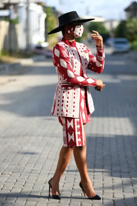 Nigerian style influencer, Angel Obasi, 24, poses for a picture with a fabric face mask on, with colours matching her clothes, following the spread of coronavirus disease (COVID-19) in Lagos, Nigeria May 14, 2020. REUTERS/Temilade Adelaja