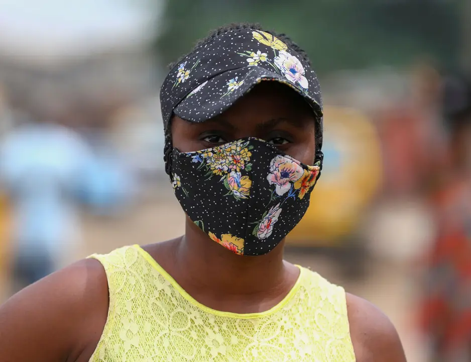 Nigerian style influencer, Angel Obasi, 24, poses for a picture with a fabric face mask on, with colours matching her clothes, following the spread of coronavirus disease (COVID-19) in Lagos, Nigeria May 14, 2020. REUTERS/Temilade Adelaja
