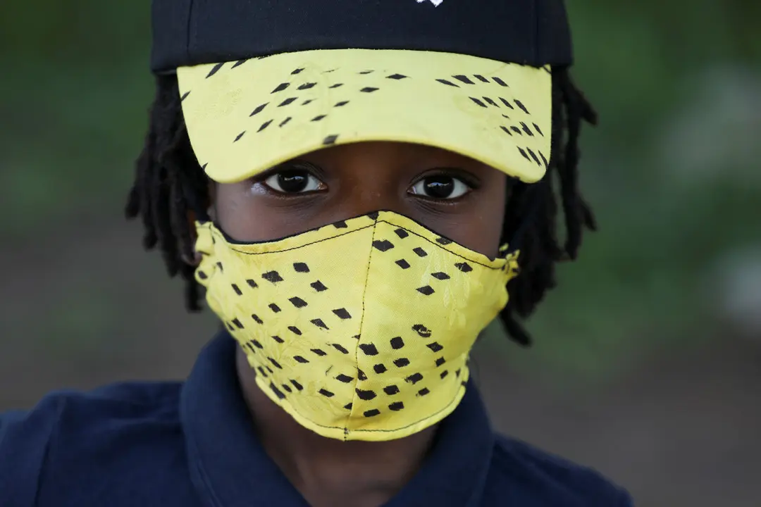 Fashion designer Sophie Zinga poses with a face mask, which she designed as a protective measure to stem the growing spread of the coronavirus disease (COVID-19), at her workshop in Dakar, Senegal May 14, 2020. REUTERS/Christophe Van Der Perre