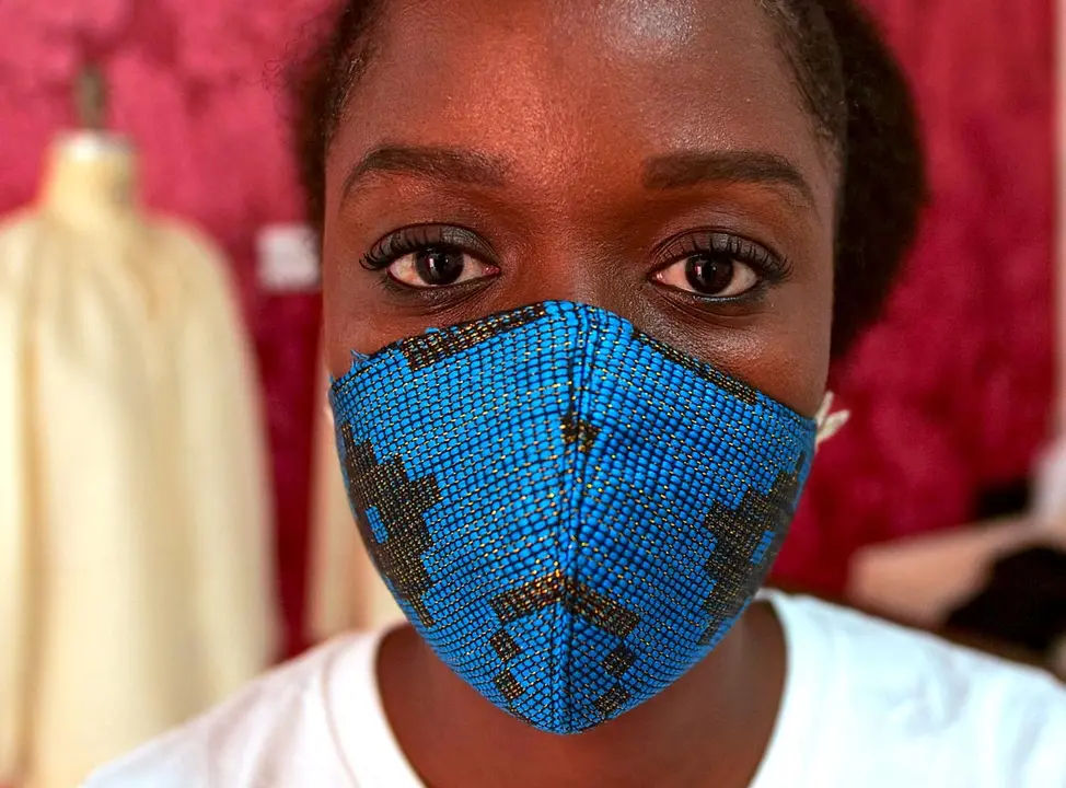A tailor, wearing a protective face mask matching his shirt, works at the workshop of fashion designer Sophie Zinga, in Dakar, Senegal May 14, 2020. REUTERS/Christophe Van Der Perre