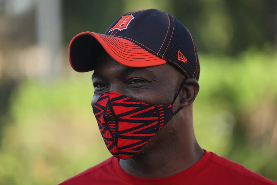 A man looks on as he wears a protective face mask with colors matching his clothes, amid the coronavirus disease (COVID-19) outbreak, in Angre area of Abidjan, Ivory Coast May 13, 2020. REUTERS/Luc Gnago