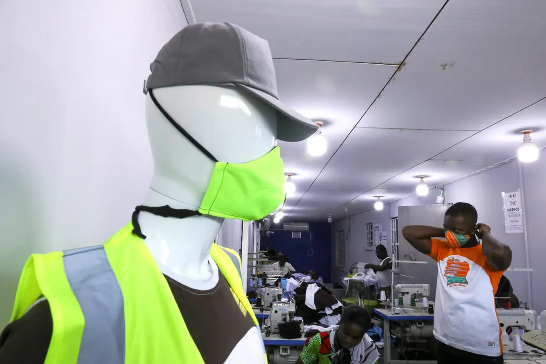 A mannequin wearing a protective face mask with colors matching its clothes is pictured at the worksop of Arthur Bella N&#39;guessan, an Ivorian designer, amid the coronavirus disease (COVID-19) outbreak, in Angre area of Abidjan, Ivory Coast 13, 2020. REUTERS/Luc Gnago
