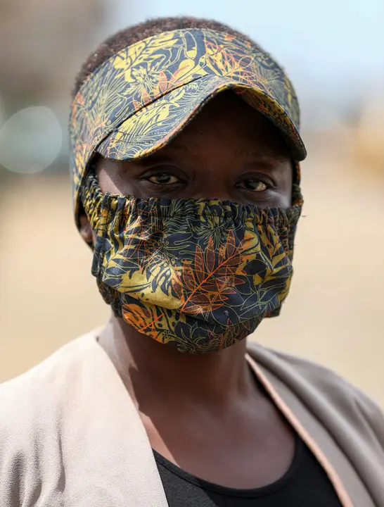 A woman poses for a picture with a fabric face mask on, matching with her hat, following the spread of the coronavirus disease (COVID-19) in Lagos, Nigeria May 13, 2020. REUTERS/Temilade Adelaja
