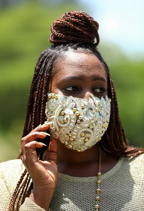 Nigerian fashion stylist Sefiya Diejomoah, 35, poses for a picture with a blinged-out face mask matching with her clothes, following the spread of the coronavirus disease (COVID-19) in Lagos, Nigeria May 14, 2020. REUTERS/Temilade Adelaja