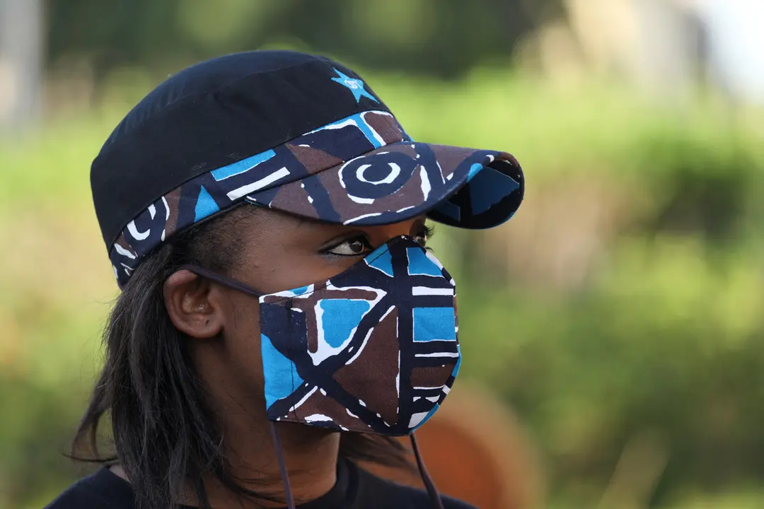 A model of Arthur Bella N&#39;guessan, an Ivorian designer, looks on as she wears a protective face mask in colors matching her clothes, amid the coronavirus disease (COVID-19) outbreak, in Angre area of Abidjan, Ivory Coast May 13, 2020. REUTERS/Luc Gnago