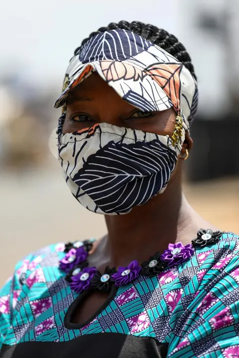 Nigerian fashion stylist, Angela Innocent, 38, poses for a picture with a fabric face mask matching her hat, following the spread of the coronavirus disease (COVID-19) in Lagos, Nigeria May 13, 2020. REUTERS/Temilade Adelaja.