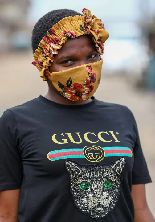 Uche Helen, a Nigerian student, 17, poses for a picture with a fabric face mask matching her head-band, following the spread of the coronavirus disease (COVID-19) in Lagos, Nigeria May 13, 2020. REUTERS/Temilade Adelaja