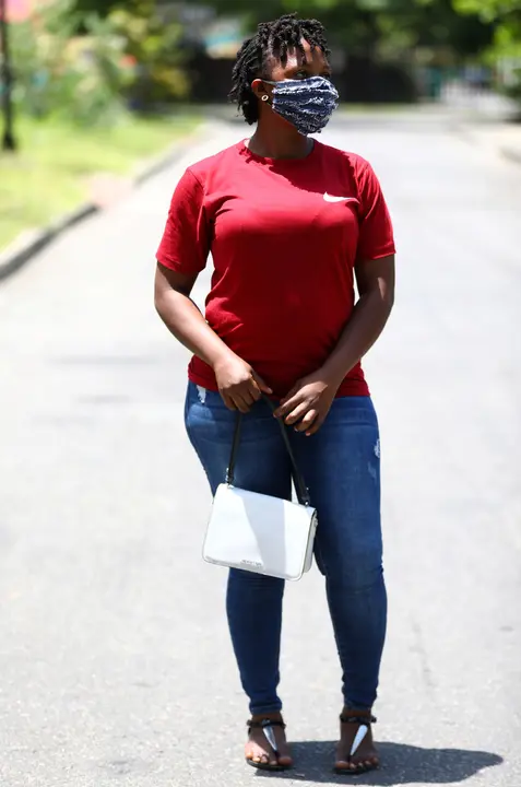 A woman poses for a picture with a fabric face mask on, following the spread of coronavirus disease (COVID-19) in Lagos, Nigeria May 14, 2020. REUTERS/Temilade Adelaja
