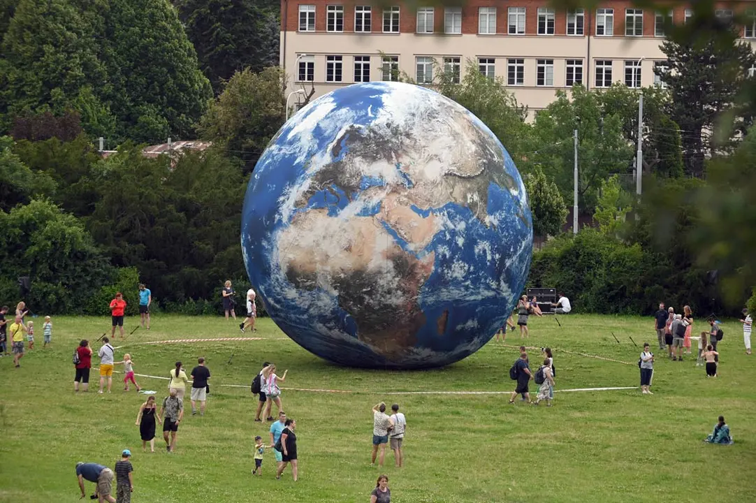 Czech Republic, Brno: People watch the giant inflatable Earth planet which is displayed near Brno Observatory and Planetarium. Photo: Igor Zehl/CTK/dpa