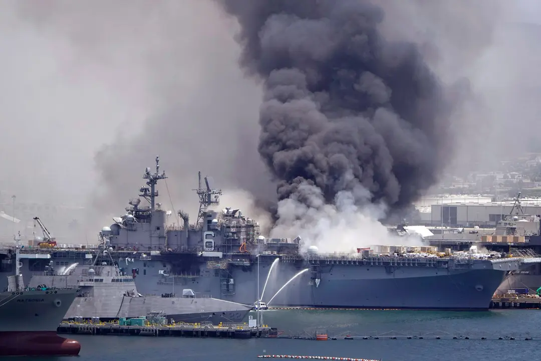 Smoke billows out of the the US Navy amphibious assault ship USS Bonhomme Richard at Naval Base San Diego during after a fire that broke out in the ship. Photo: K.C. Alfred/dpa.