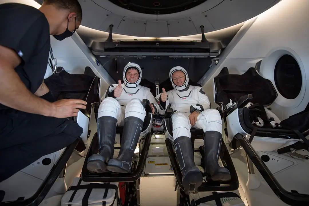 02 August 2020, US, Pensacola: NASA astronauts Robert Behnken (L) and Douglas Hurley seen inside the SpaceX Crew Dragon Endeavour spacecraft onboard the SpaceX GO Navigator recovery ship shortly after having landed in the Gulf of Mexico off the coast of Pensacola. The Demo-2 test flight for NASA&#39;s Commercial Crew Program is the first to deliver astronauts to the International Space Station and return them to Earth onboard a commercially built and operated spacecraft. Behnken and Hurley are returning after spending 64 days in space. Photo: Bill Ingalls/NASA/dpa