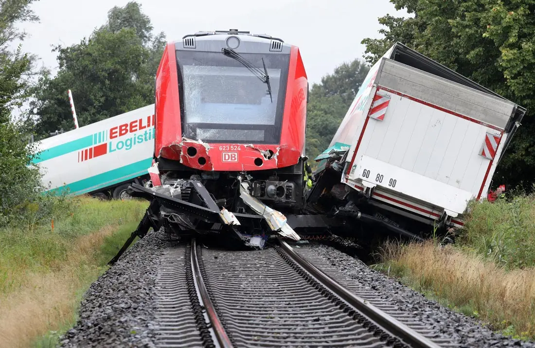 26 August 2020, Mecklenburg-Western Pomerania, Bad Kleinen: A general view of a damaged regional train and debris of a lorry truck lie on the tracks after it collided the train. Photo: Bernd Wüstneck/dpa.