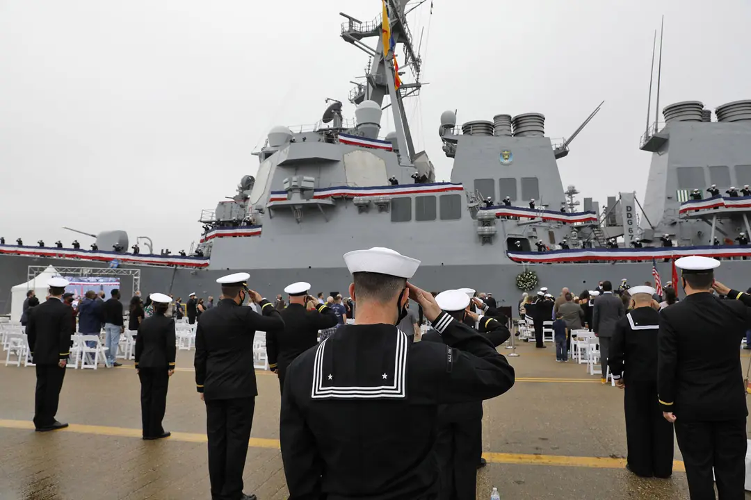 12 October 2020, US, Newport News: Sailors salute the presentation of colors during a remembrance ceremony commentating the 20th anniversary of the attack on USS Cole bombing. Photo: Jonathon Gruenke/dpa.