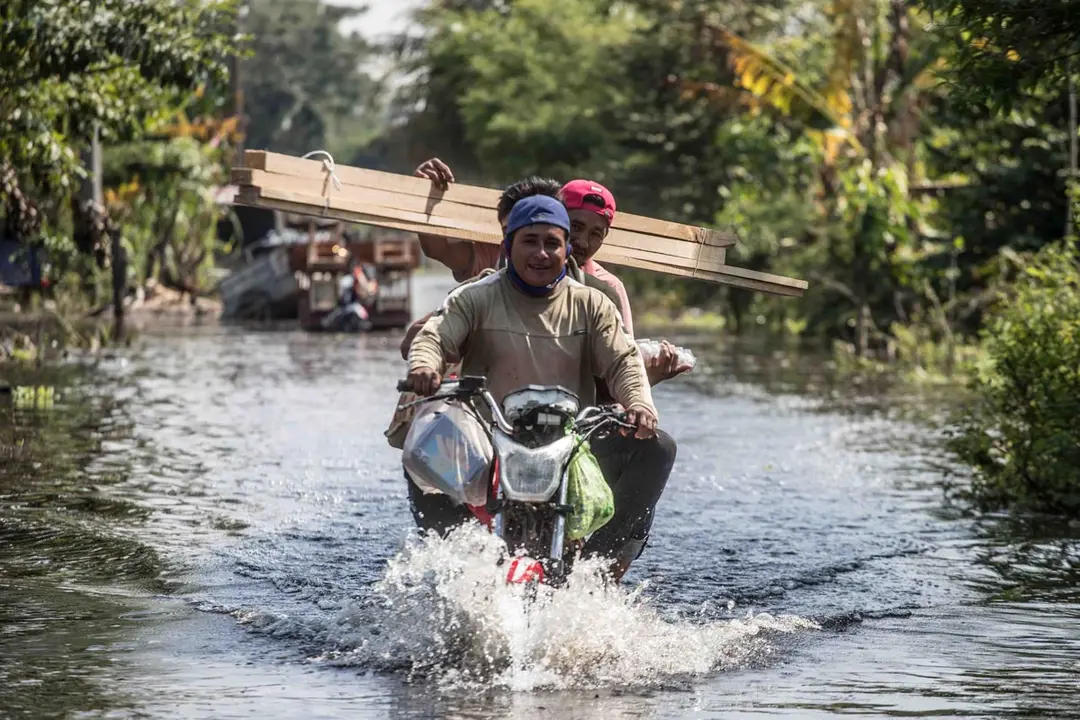 11 November 2020, Mexico, Nacajuca: Three men ride a motorcycle in a flooded street after heavy rains hit the Tabasco state. Photo: -/El Universal via ZUMA Wire/dpa