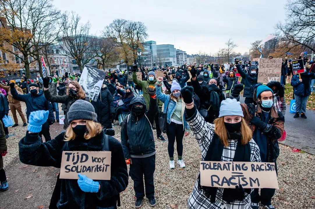 06 December 2020, Netherlands, The Hague: Protesters wearing face masks raise their fists in support of Black Lives Matter movement during a demonstration against racism and inequality. Photo: Ana Fernandez/SOPA Images via ZUMA Wire/dpa