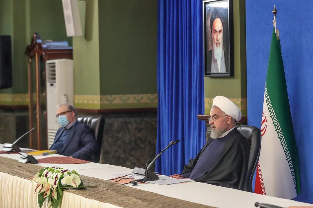 HANDOUT - 19 December 2020, Iran, Tehran: Iranian President Hassan Rouhani (R) chairs a meeting of the National Task Force Against Coronavirus (COVID-19). Photo: Ebrahim Seydi/Iranian Presidency/dpa - ATTENTION: editorial use only and only if the credit mentioned above is referenced in full