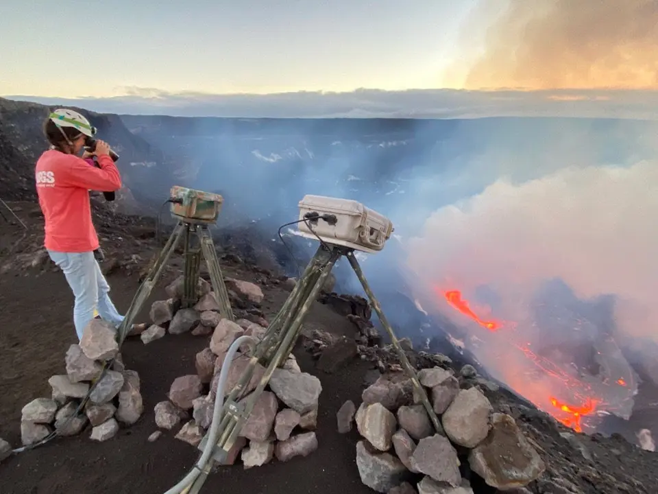 21 December 2020, US, Hawaii: A scientist watches the steam and gas which plume from the eruption in Halemaumau crater after Hawaii's Kilauea volcano became active on Sunday. Photo: -/ZUMA Wire/dpa