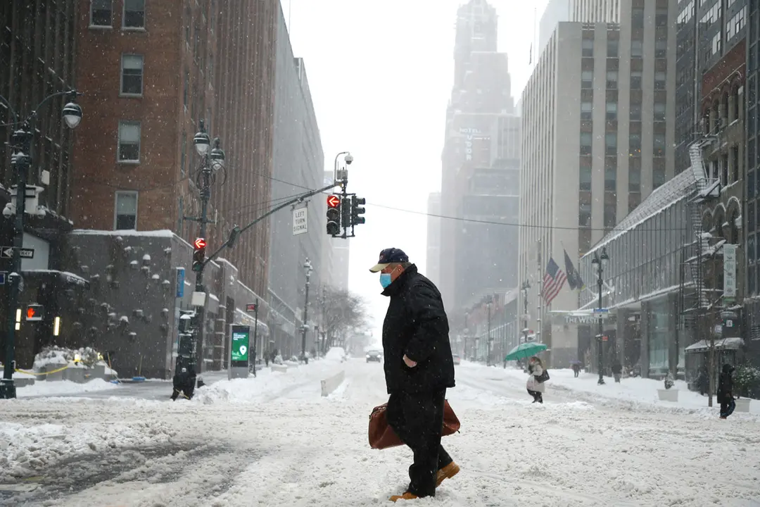 01 February 2021, US, New York: A man walks across a street during heavy snowfall in New York City. Photo: John Lamparski/SOPA Images via ZUMA Wire/dpa