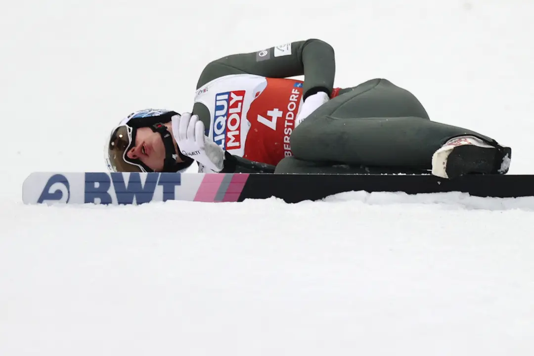 27 February 2021, Bavaria, Oberstdorf: Finland's Eetu Nousiainen lies on the ground after a crash during the first roudn of the men's ski jumping normal hill at the FIS Nordic World Ski Championships in Oberstdorf. Photo: Daniel Karmann/dpa