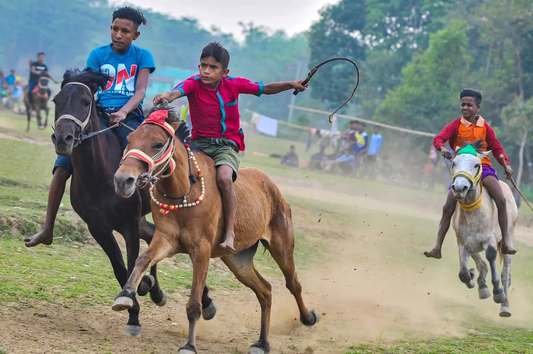 06 March 2021, Bangladesh, Sunamganj: Young jockeys compete in a traditional rural horse race. Photo: Md Rafayat Haque Khan/ZUMA Wire/dpa