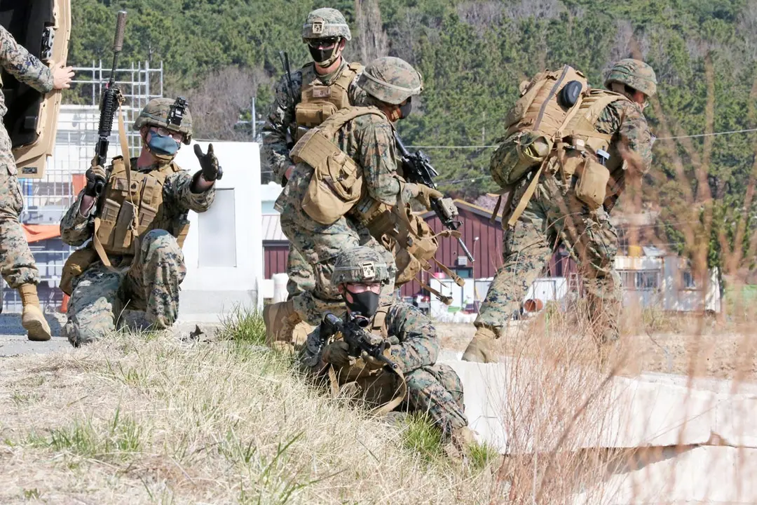 25 March 2021, South Korea, Pohang: US Marines stand guard after infiltrating an inland area during a joint drill with their South Korean counterparts on the coast of South Korea's southeastern port city of Pohang. North Korea fired what appeared to be two short-range ballistic missiles into the East Sea earlier in the day. Photo: -/YNA/dpa