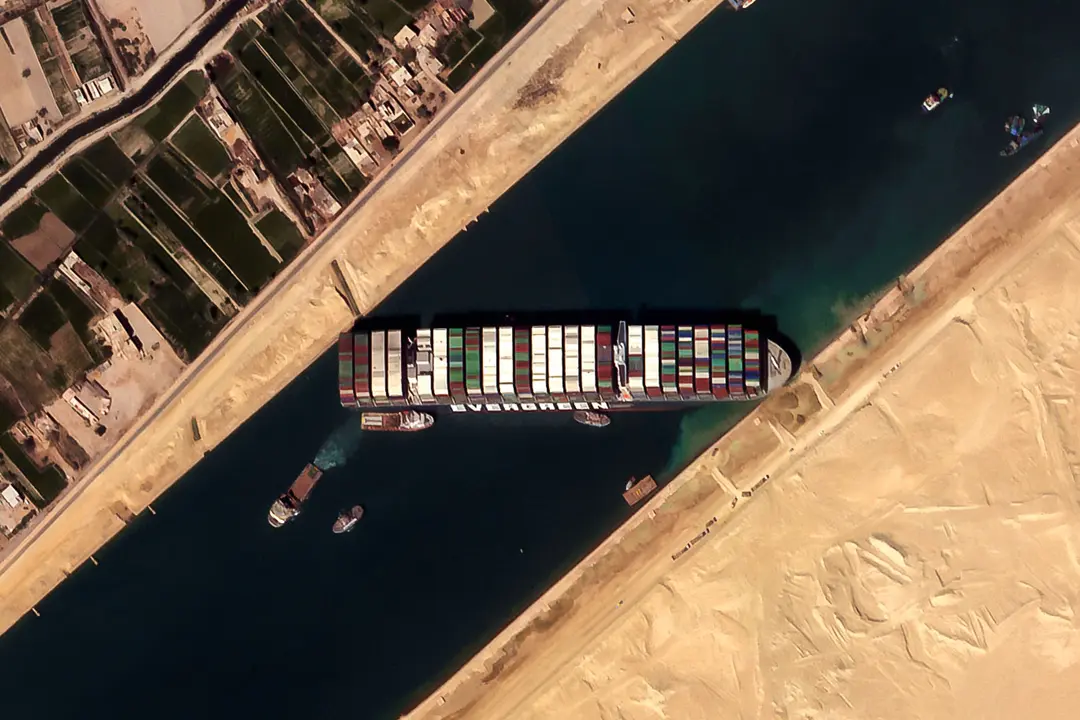 HANDOUT - 26 March 2021, Egypt, Suez: A satellite image provided by the European Space Imaging on 26 March 2021 shows the 'Ever given', a container ship operated by the Evergreen Marine Corporation, is currently stuck in the Suez Canal. The state-run Suez Canal Authority (SCA) announced that nearly 17,000 cubic meters of sand have been dredged around the ship after navigation through the Suez Canal has been temporarily suspended until the full refloating of the Panamanian massive cargo vessel which ran aground on Tuesday in the southern end of the Suez Canal and blocked the traffic in both directions. The ship turned sideways in the Canal, while on the route from China to Rotterdam, due to reduced visibility that resulted from a dust storm hitting the area, according to SCA. Photo: -/European Space Imaging/dpa - ATTENTION: editorial use only and only if the credit mentioned above is referenced in full