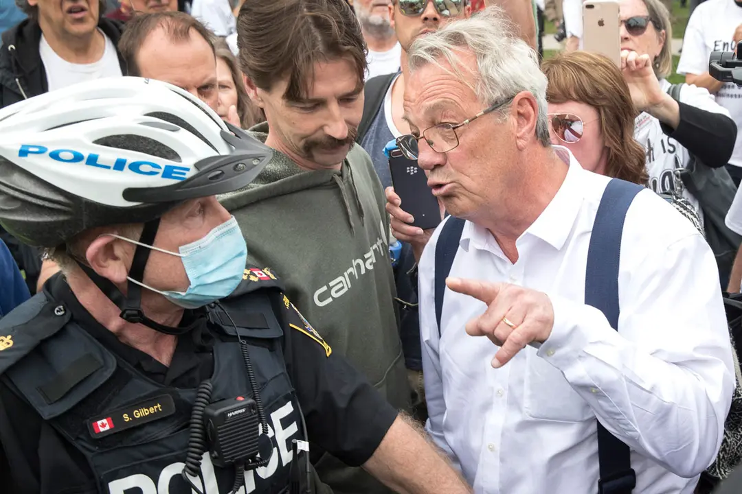 24 April 2021, Canada, Peterborough: Randy Hillier, independent member of Provincial Parliament of Ontario, argues with police at a protest against government measures to curb the spread of Coronavirus (COVID-19). Photo: Fred Thornhill/The Canadian Press via ZUMA/dpa
