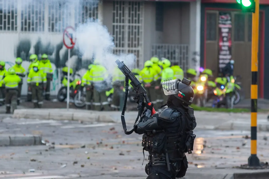 30 April 2021, Colombia, Bogota: A riot police officer fires tear gas during a protest against the tax reform bill proposed by the government. Photo: Chepa Beltran/LongVisual via ZUMA Wire/dpa