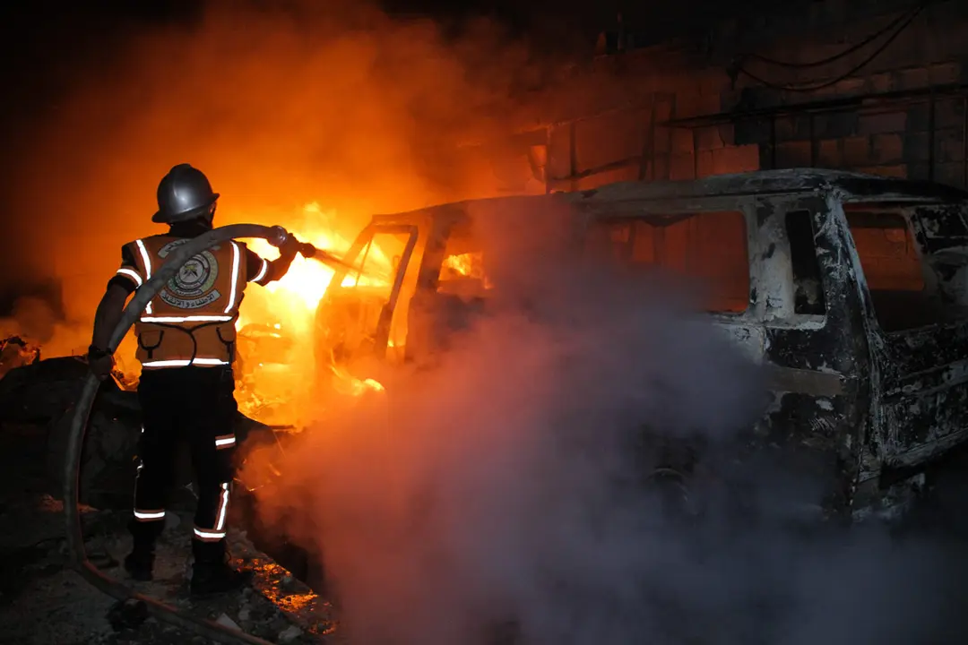 11 May 2021, Palestinian Territories, Beit Lahia: A firefighter of the Palestinian Civil Defence battles to extinguish a fire caused by an Israeli airstrike in the city of Beit Lahia, in the northern Gaza Strip, amid the escalating flare-up of Israeli-Palestinian violence. Hundreds of rockets have been fired upon Israel from Palestinian militants in the Gaza Strip throughout Tuesday, while Israel pummels the tiny coastal territory with airstrikes. Photo: Ahmad Hasaballah/IMAGESLIVE via ZUMA Wire/dpa