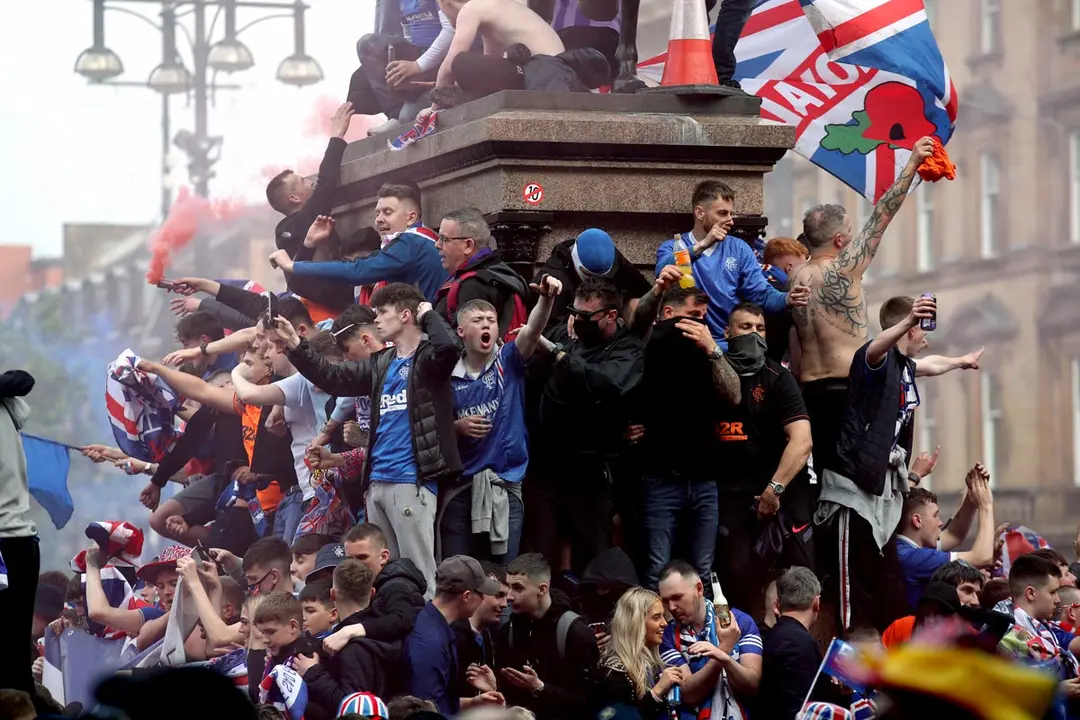 15 May 2021, United Kingdom, Glasgow: Glasgow Rangers fans celebrate outside Ibrox Stadium after their team won the Scottish Premiership final soccer match against Aberdeen. Photo: Andrew Milligan/PA Wire/dpa
