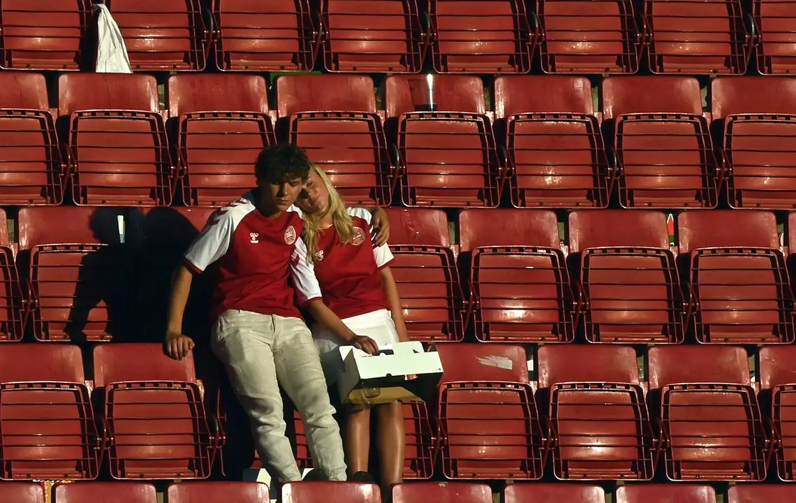 17 June 2021, Denmark, Copenhagen: Danish supporters look dejected after the UEFA EURO 2020 Group B soccer match between Denmark and Belgium at Parken stadium. Photo: Dirk Waem/BELGA/dpa