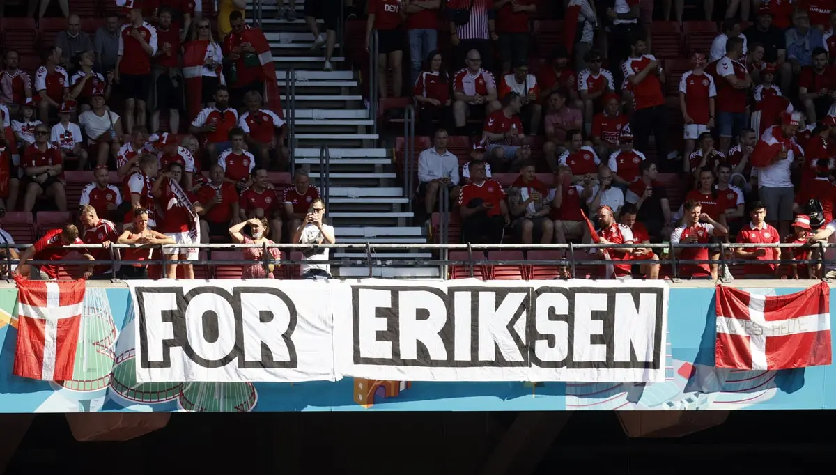 17 June 2021, Denmark, Copenhagen: Danish fans cheer in the stands as a placed banner reading "For Eriksen" is pictured before the start of the UEFA EURO 2020 Group B soccer match between Denmark and Belgium at Parken stadium. Photo: Bruno Fahy/BELGA/dpa
