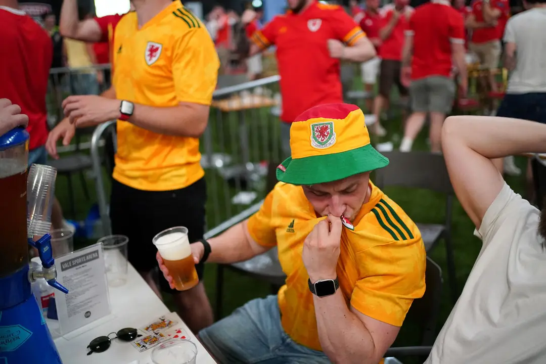 16 June 2021, United Kingdom, Cardiff: Wales fans react to the second goal while watching the UEFA Euro 2020 Group A soccer match between Turkey and Wales at the Vale Sports Arena. Photo: Jacob King/PA Wire/dpa