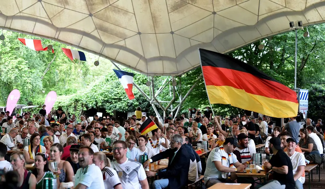 15 June 2021, North Rhine-Westphalia, Essen: Fans sit at the music pavilion in the Grugapark as they watch the UEFA EURO 2020 Group F soccer match between France and Germany. Photo: Caroline Seidel/dpa