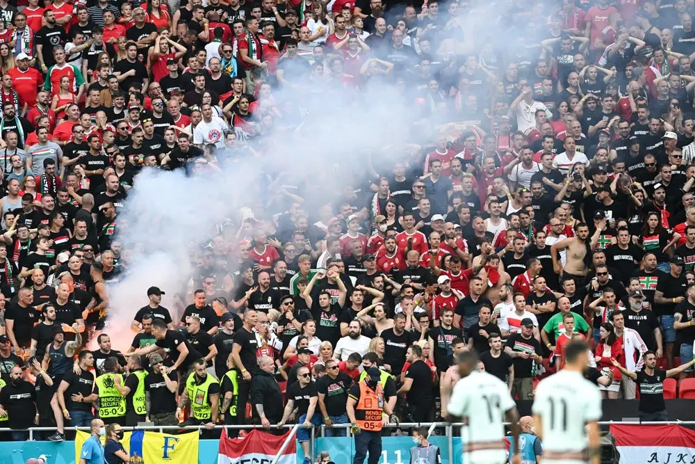 15 June 2021, Hungary, Budapest: Hungarian fans light a smoke flare in the stands after the final whistle of the UEFA EURO 2020 Group F soccer match between Hungary and Portugal at the Puskas Arena. Photo: Robert Michael/dpa-Zentralbild/dpa