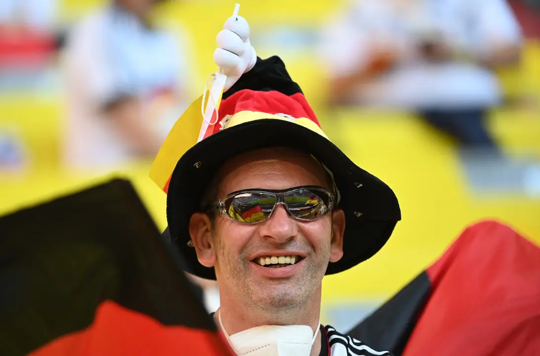 15 June 2021, Bavaria, Munich: A fan cheers in the stands before the start of the UEFA EURO 2020 Group F soccer match between France and Germany at the Allianz Arena. Photo: Federico Gambarini/dpa