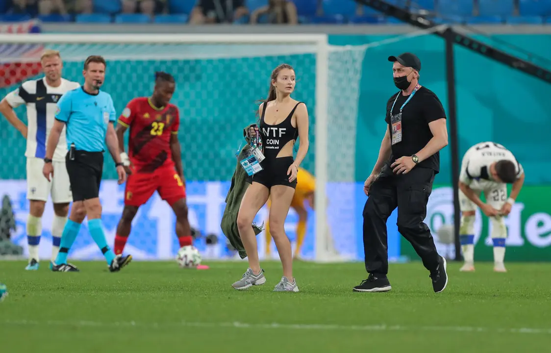 21 June 2021, Russia, Saint Petersburg: A woman is stopped on the pitch during the UEFA EURO 2020 Group B soccer match between Finland and Belgium at Saint Petersburg stadium. Photo: Igor Russak/dpa.