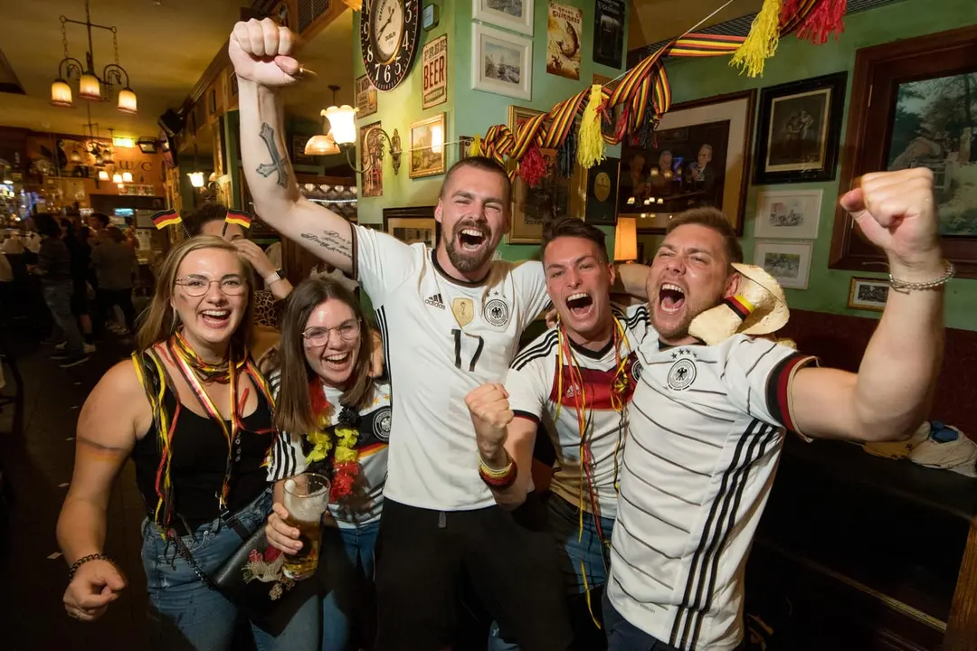23 June 2021, Bavaria, Munich: Germany fans celebrate as they watch the UEFA EURO 2020 Group F soccer match between Germany and Hungary at Kennedy's Bar. Photo: Tobias Hase/dpa