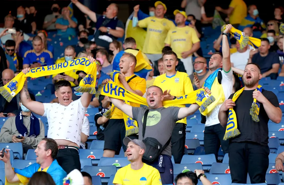 29 June 2021, United Kingdom, Glasgow: Ukraine fans cheer in the stands before the start of the UEFA EURO 2020 round of 16 soccer match between Sweden and Ukraine at Hampden Park. Photo: Jane Barlow/PA Wire/dpa