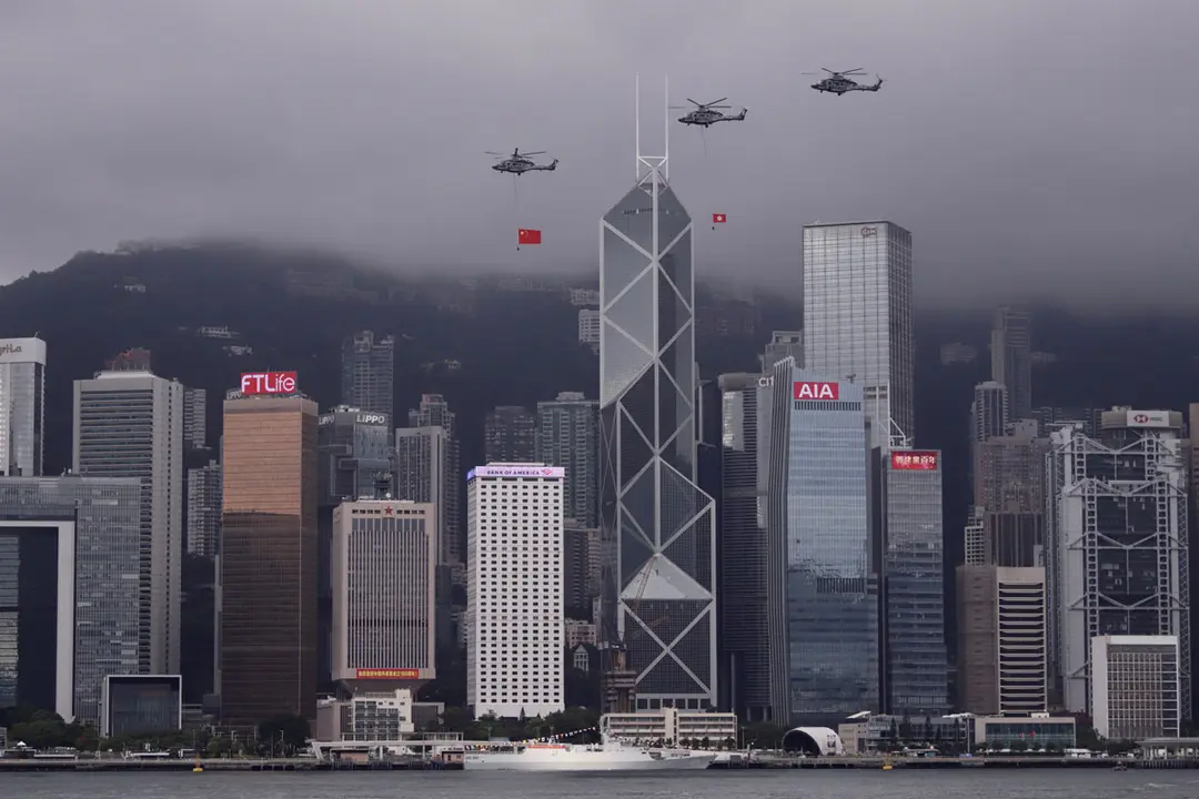 01 July 2021, China, Hong Kong: Helicopters fly past Central, displaying PRC national flag and Hong Kong official flag over the sky of Victoria Harbour in the morning of the 24th anniversary of Hong Kong's Handover and 100th anniversary of the Chinese Communist Party. Photo: Liau Chung-Ren/ZUMA Wire/dpa