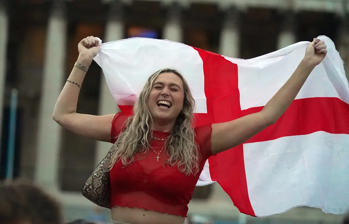 03 July 2021, United Kingdom, London: A fan in Trafalgar Square celebrate Harry Maguire's second goal while watching the UEFA EURO 2020 Quarter-Final soccer match between Ukraine and England during a public screening for the match. Photo: Victoria Jones/PA Wire/dpa
