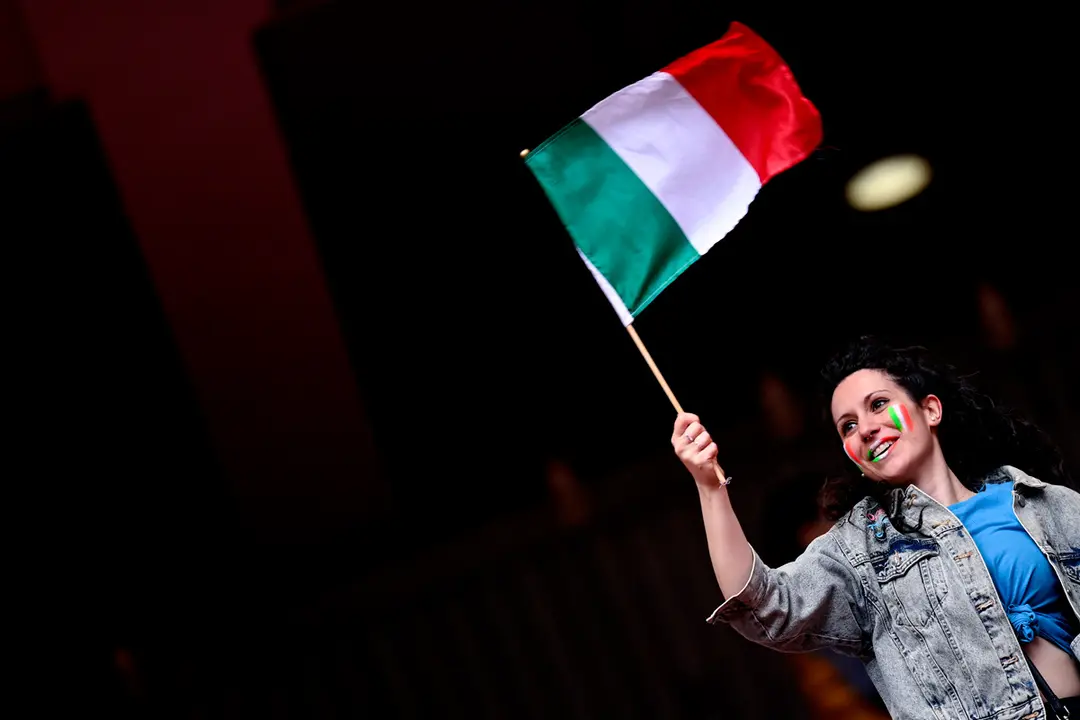 06 July 2021, United Kingdom, London: An Italy fan waves an Italian flag prior to the start of the UEFA EURO 2020 semi final soccer match between Italy and Spain at Wembley Stadium. Photo: Fabio Ferrari/LaPresse via ZUMA Press/dpa