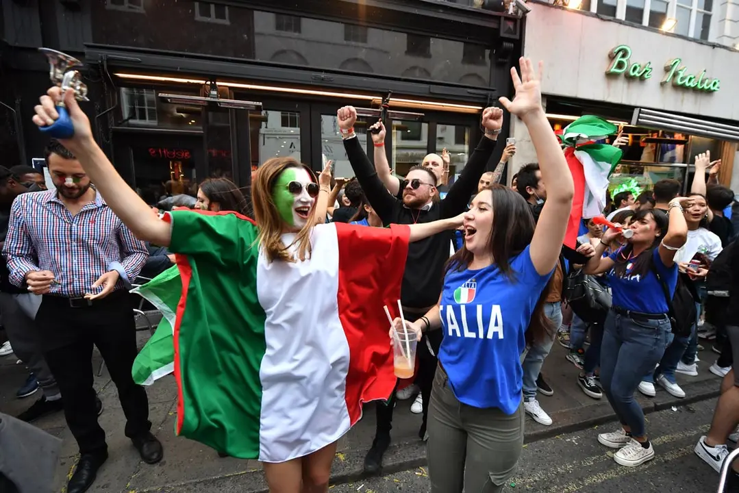 11 July 2021, United Kingdom, London: Italy fans gather outside the Little Italy Restaurant in Soho ahead of the UEFA EURO 2020 final soccer match between Italy and England, which to take place later in the day at Wembley Stadium. Photo: Dominic Lipinski/PA Wire/dpa