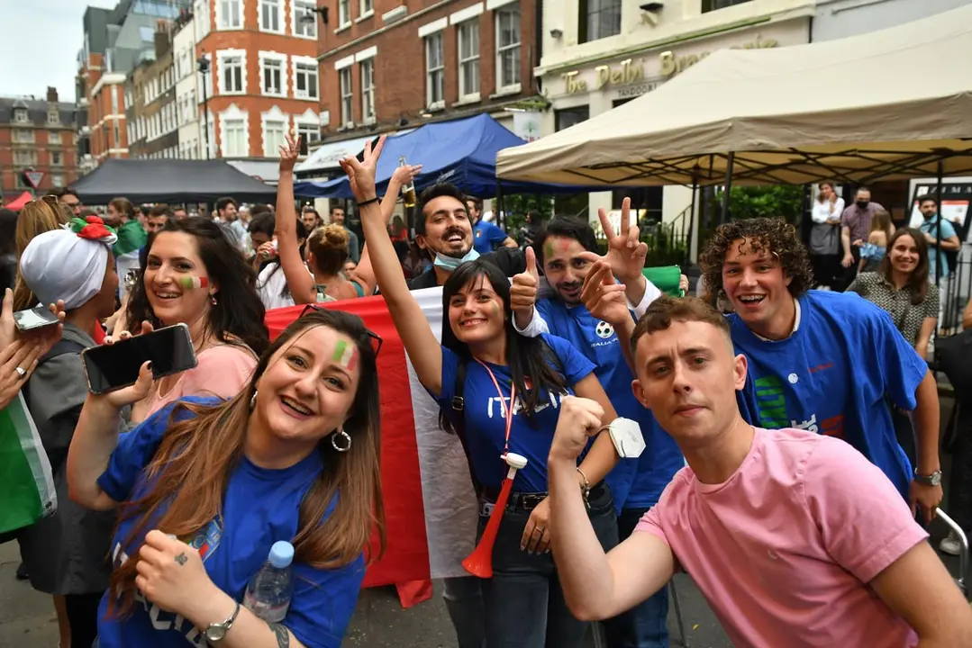 11 July 2021, United Kingdom, London: Italy fans gather outside the Little Italy Restaurant in Soho ahead of the UEFA EURO 2020 final soccer match between Italy and England, which to take place later in the day at Wembley Stadium. Photo: Dominic Lipinski/PA Wire/dpa