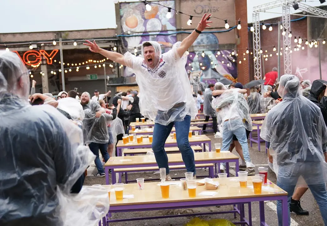 11 July 2021, United Kingdom, Birmingham: England fans celebrate Luke Shaw's opening goal for England at Luna Springs as they watch the UEFA EURO 2020 final soccer match between Italy and England. Photo: Jacob King/PA Wire/dpa
