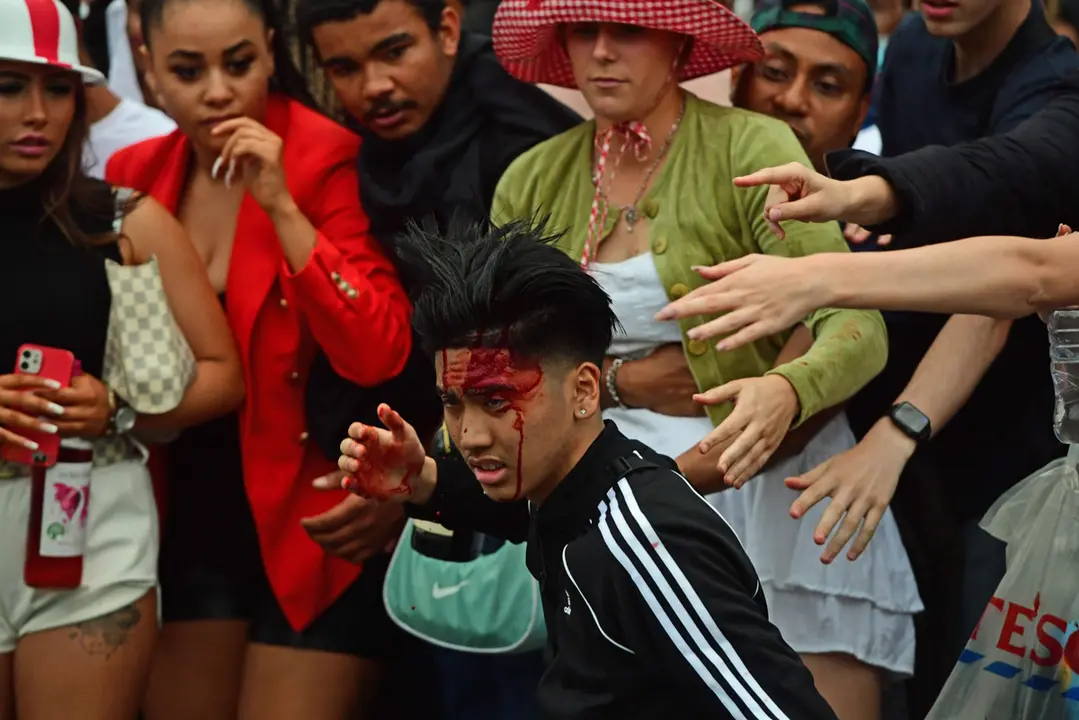 11 July 2021, United Kingdom, London: An injured England fan is seen on the steps of the National Gallery, in Trafalgar Square during the UEFA EURO 2020 final soccer match between Italy and England. Photo: Ian West/PA Wire/dpa