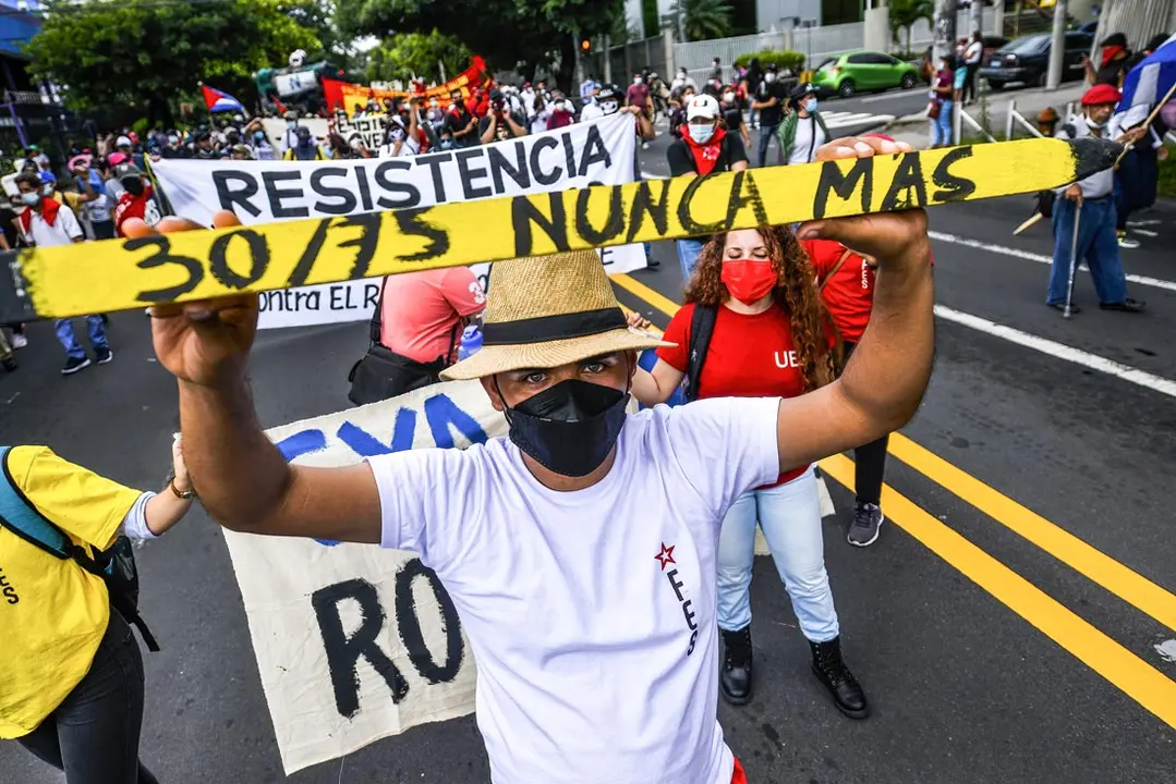 30 July 2021, El Salvador, San Salvador: Demonstrators march during a protest against the government of Salvadoran President Nayib Bukele on the 46th anniversary of a government led massacre against peacfully protesting high school and university students in 1975. Photo: Camilo Freedman/SOPA Images via ZUMA Press Wire/dpa
