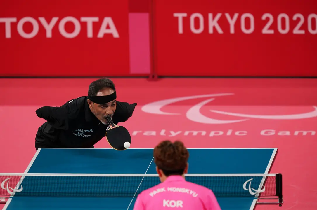 25 August 2021, Japan, Tokyo: Egypt's Ibrahim Al Husseini Hamato (L) in action during the Men's Singles Class 6 Group E Table Tennis between Egypt and South Korea at the Tokyo Metropolitan Gymnasium as part of the Tokyo 2020 Paralympic Games. Photo: Marcus Brandt/dpa
